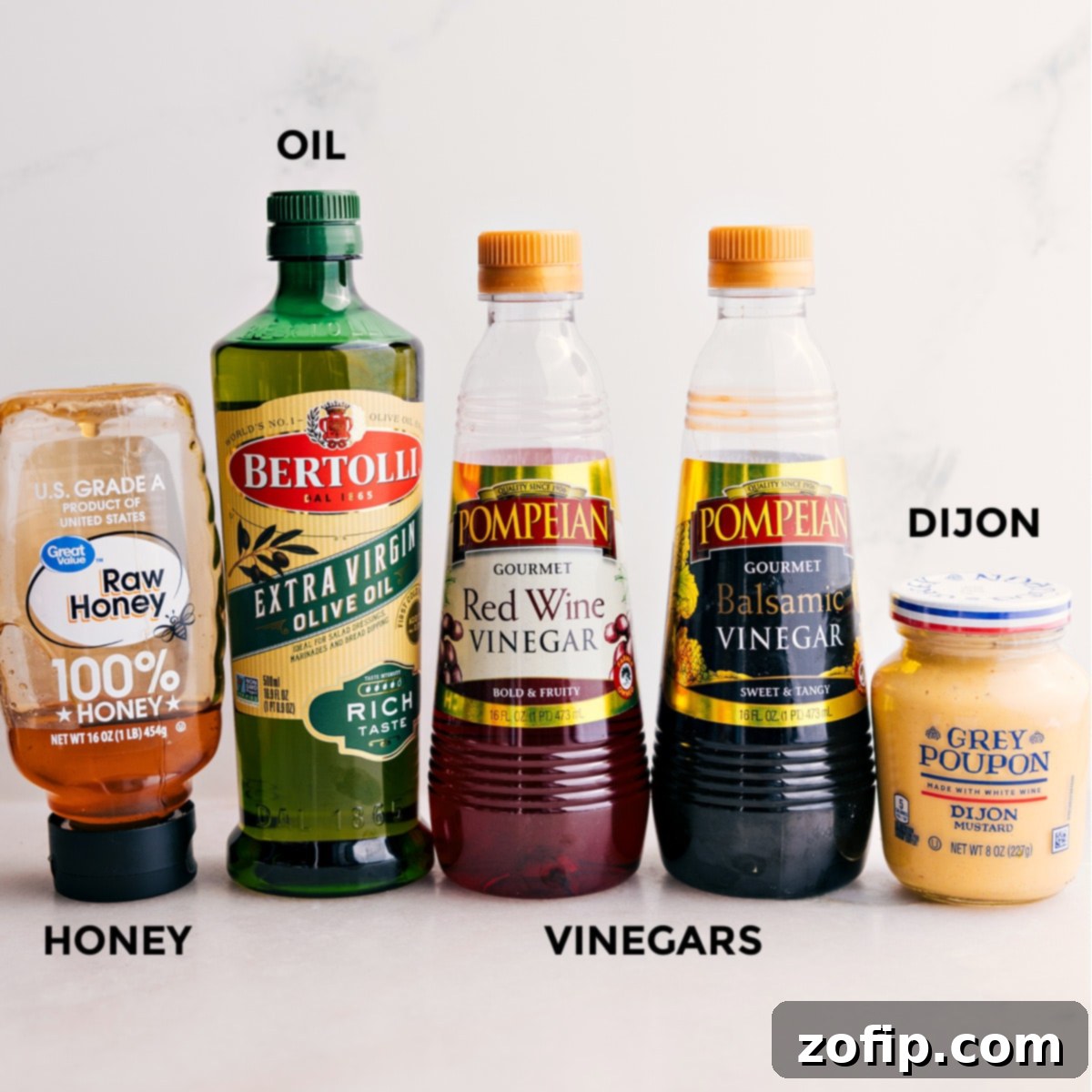 All the dressing ingredients for this Panzanella salad are prepped, including honey, oil, red wine vinegar, balsamic vinegar, and Dijon mustard. Fresh and ready to mix.