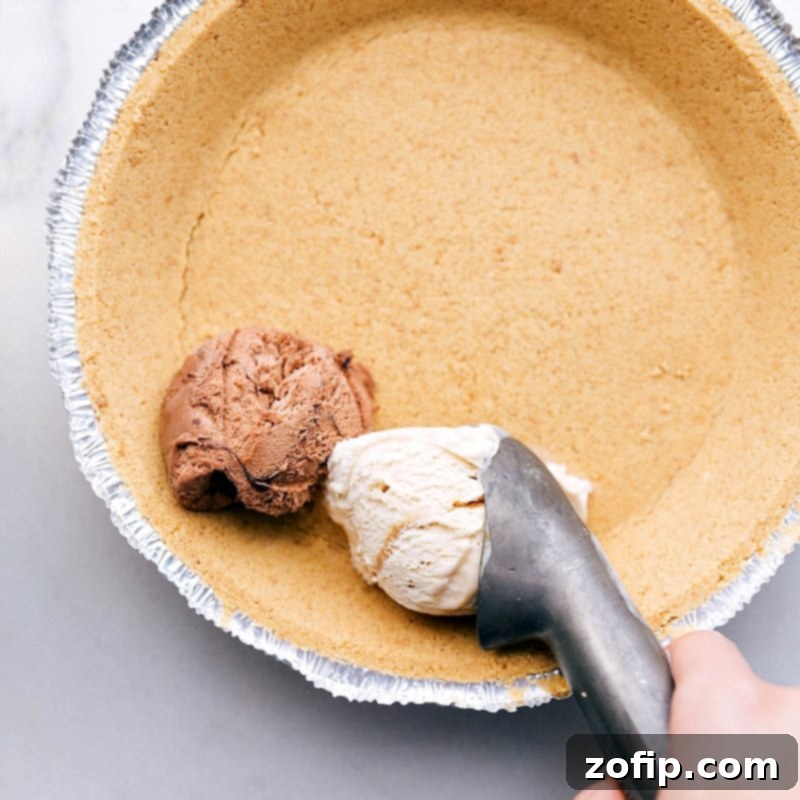 Scooping Ice Cream into Crust Layering in the different flavors into the crust.