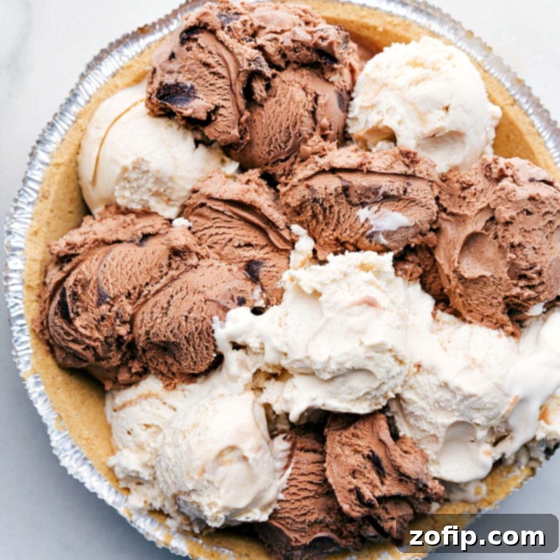 Scoops of Ice Cream in Pie Crust Ready to be Frozen Scoops of chocolate and caramel ice cream arranged in the crust, ready to be frozen.