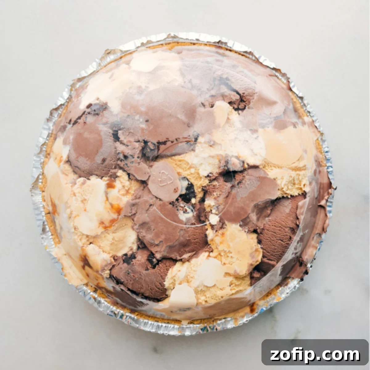 How To Make Ice Cream Pie The dessert completed and covered with the plastic lid and put in the freezer to harden.