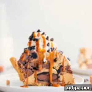 Arctic Indulgence 2 Slice of Ice Cream Pie with whipped cream, drizzle of caramel, and chocolate chips on top.