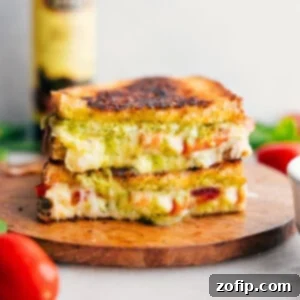 Caprese Grilled Cheese stacked on top of each other showing the cheesy center, ready to be served.