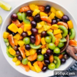 Zesty Tropical Fruit Bowl A Simple Indulgence 5 A large bowl of the Tropical Fruit Salad, glistening with dressing.