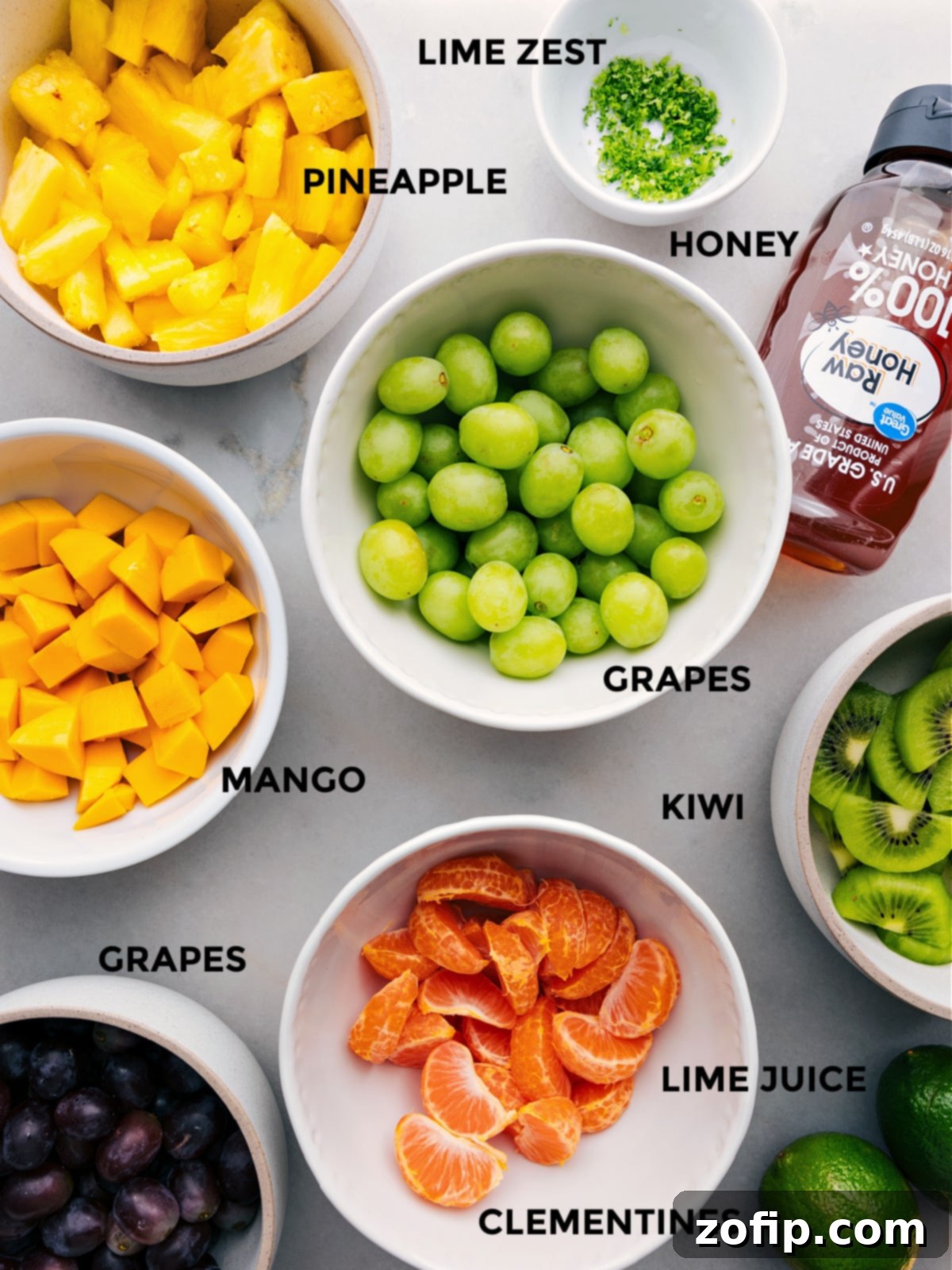 Zesty Tropical Fruit Bowl A Simple Indulgence 3 All the fresh ingredients for the Tropical Fruit Salad, meticulously prepped and laid out on a white counter, ready for easy assembly.