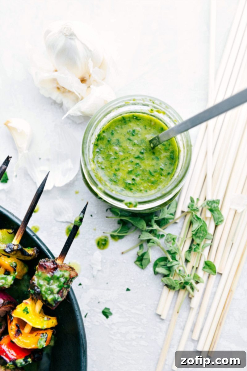 The exquisite basil sauce, the perfect complement to our grilled steak kebabs. A small bowl of fresh, vibrant basil sauce, ready to be served with steak kebabs.