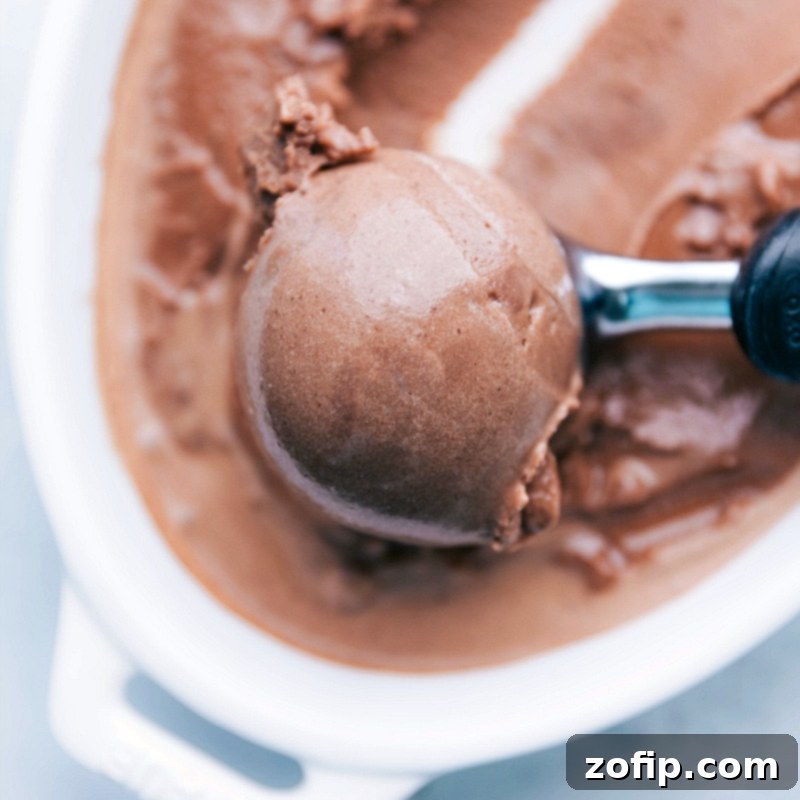 Scooping Refreshing Homemade Gelato The refreshing and flavorful dessert being scooped up with an ice cream scoop, showcasing its soft, scoopable texture.