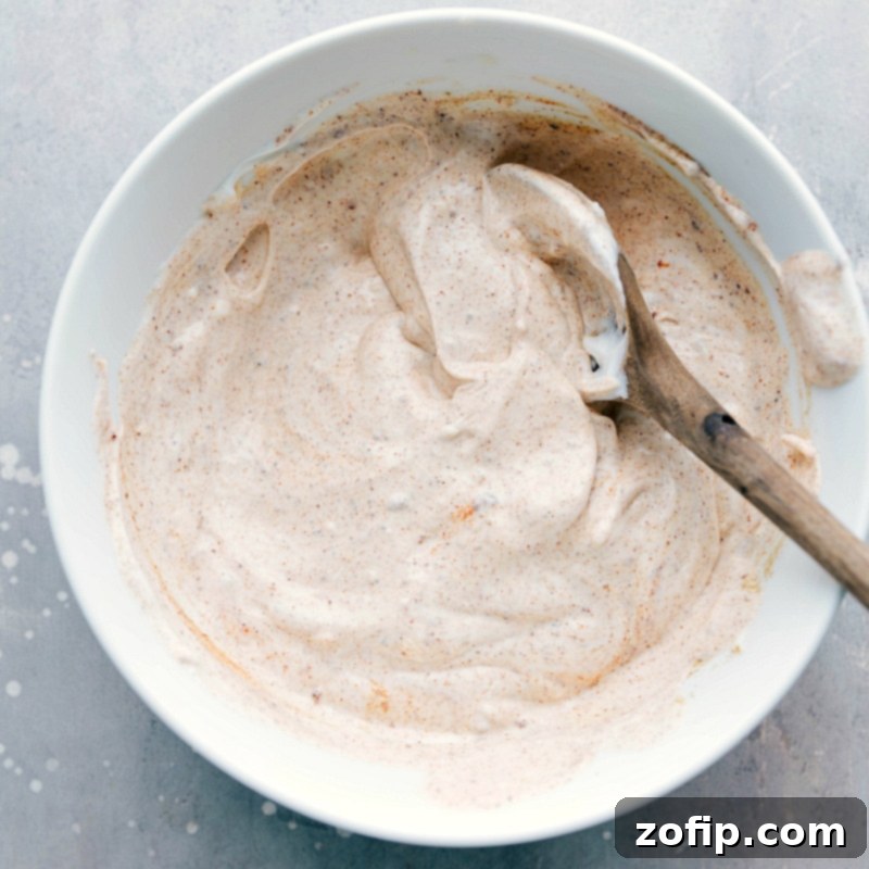 The finished sauce in a bowl, full of rich flavors, ready to enhance the dish. A perfectly blended creamy corn salad dressing.