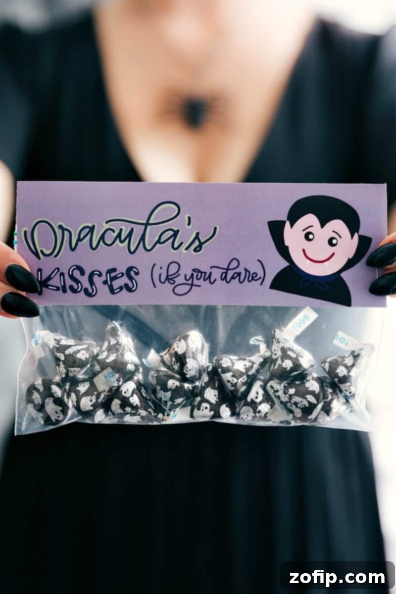 A playfully spooky 'Dracula Kisses' Halloween treat bag, topped with a vampire face design, filled with shiny foil-wrapped Hershey's Kisses.