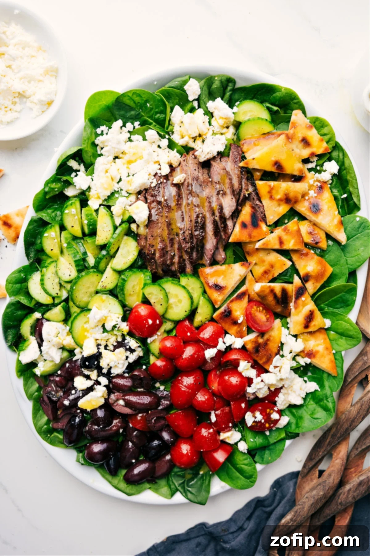 Flavorful And Fresh Grilled Steak Salad Recipe Delicious Grilled Steak Salad Recipe served over fresh spinach and drizzled with a homemade honey-lemon dressing, ready to eat, highlighting the tender steak and vibrant vegetables.