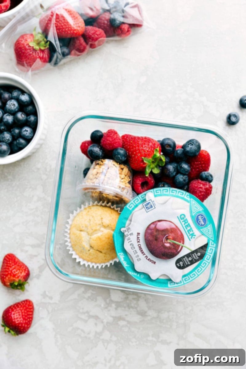 Packed Yogurt Parfait Lunch Yogurt parfait meal in a container, packed with yogurt, fresh fruit, and granola, ready to go.