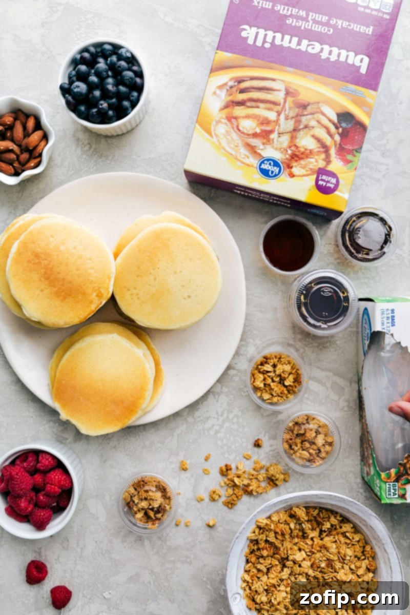 Kids School Lunch Ideas with Pancakes and Toppings Pancakes with toppings such as granola, fruit, and nuts, with syrup in containers, ready to make a perfect lunch as part of kids school lunch ideas.