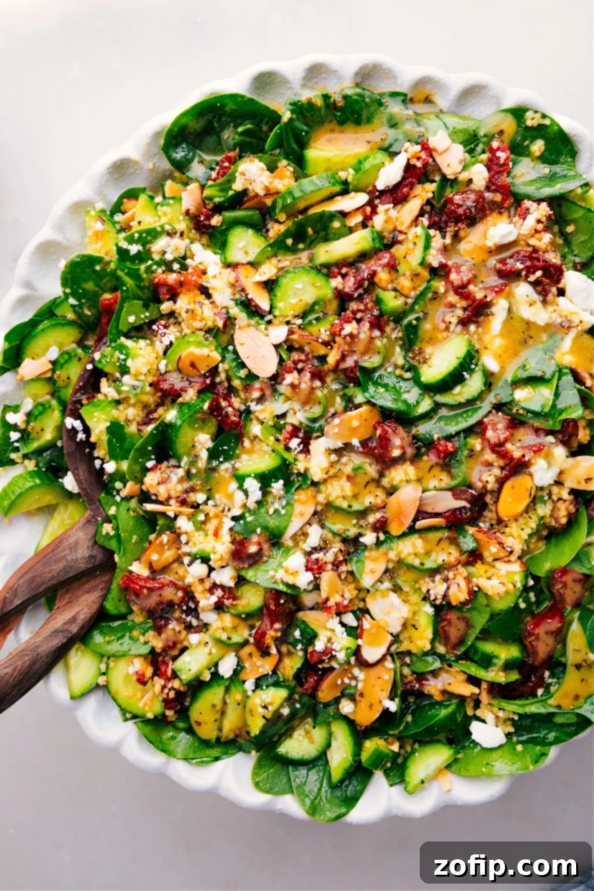 Delicious and fresh Couscous Mediterranean Salad, beautifully dressed and ready to serve in a large bowl.