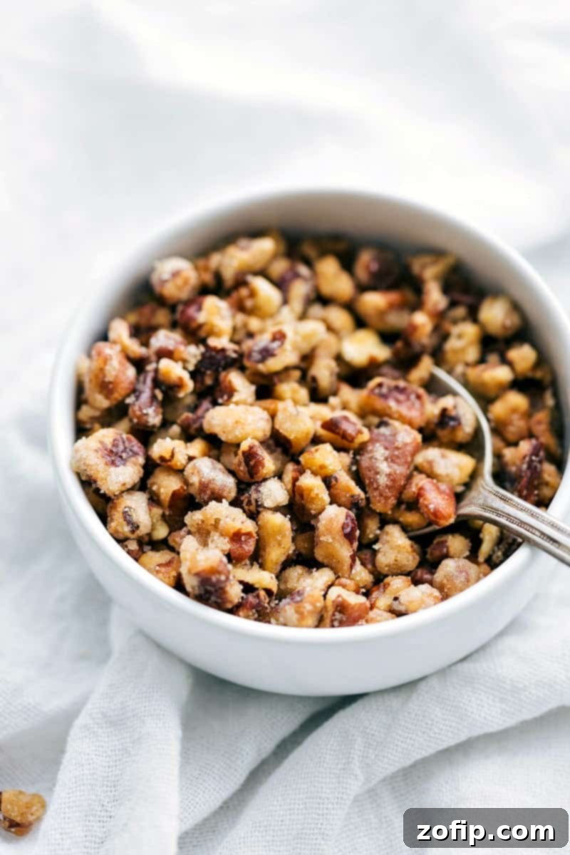 Delicious roasted butternut squash with herbs and spices, perfectly cooked and ready to be added to bowls. This image highlights the golden-brown color and tender texture of the squash.