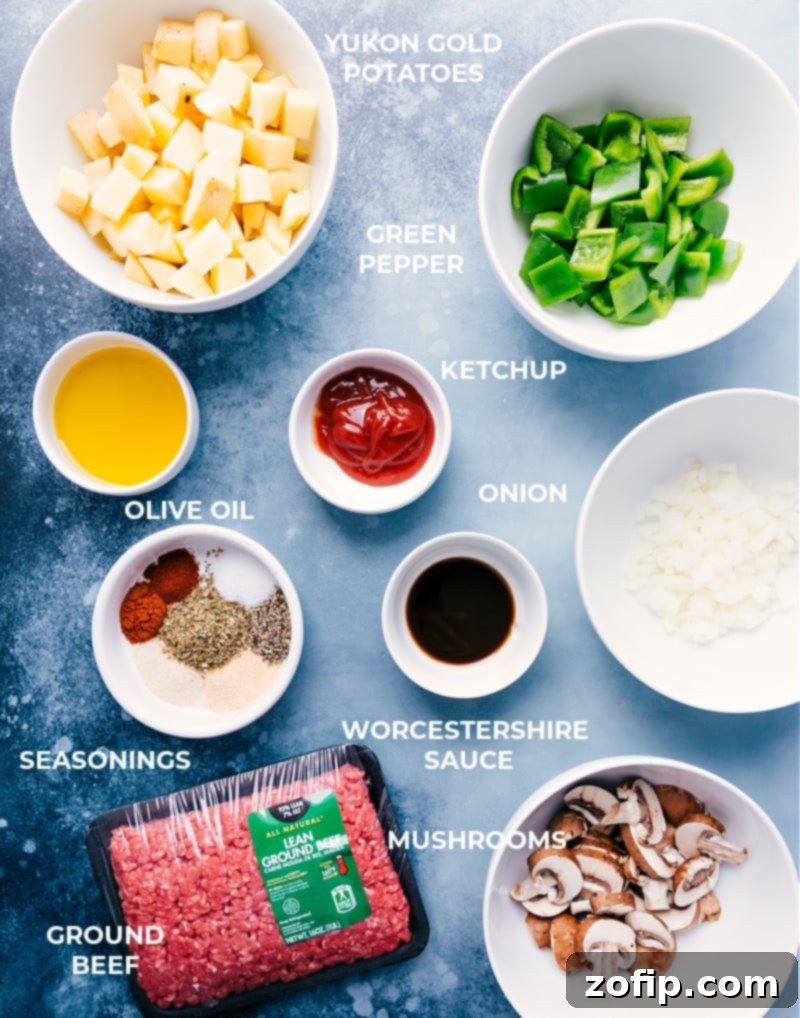 Fresh ingredients for making Philly Cheesesteak Foil Packs including ground beef, potatoes, peppers, onions, and mushrooms