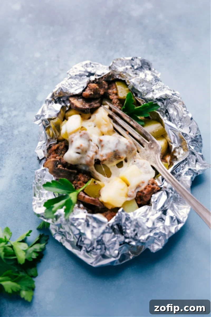 A perfectly cooked Philly Cheesesteak Foil Pack, ready to be enjoyed with melted Provolone cheese