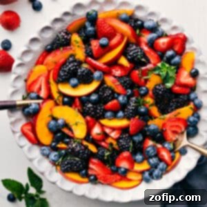 Close-up of a vibrant Peach Fruit Salad with fresh berries and mint