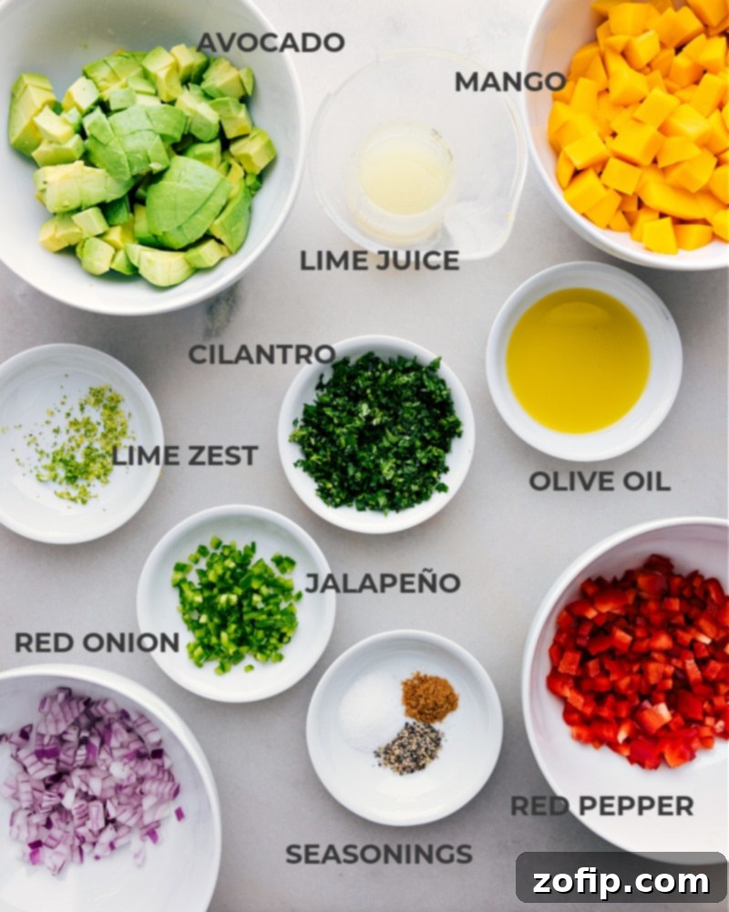Key Ingredients for Our Irresistible Mango Salsa A vibrant array of fresh ingredients laid out, including diced mango, avocado, red bell pepper, jalapeño, red onion, cilantro, and limes, ready for the mango salsa recipe