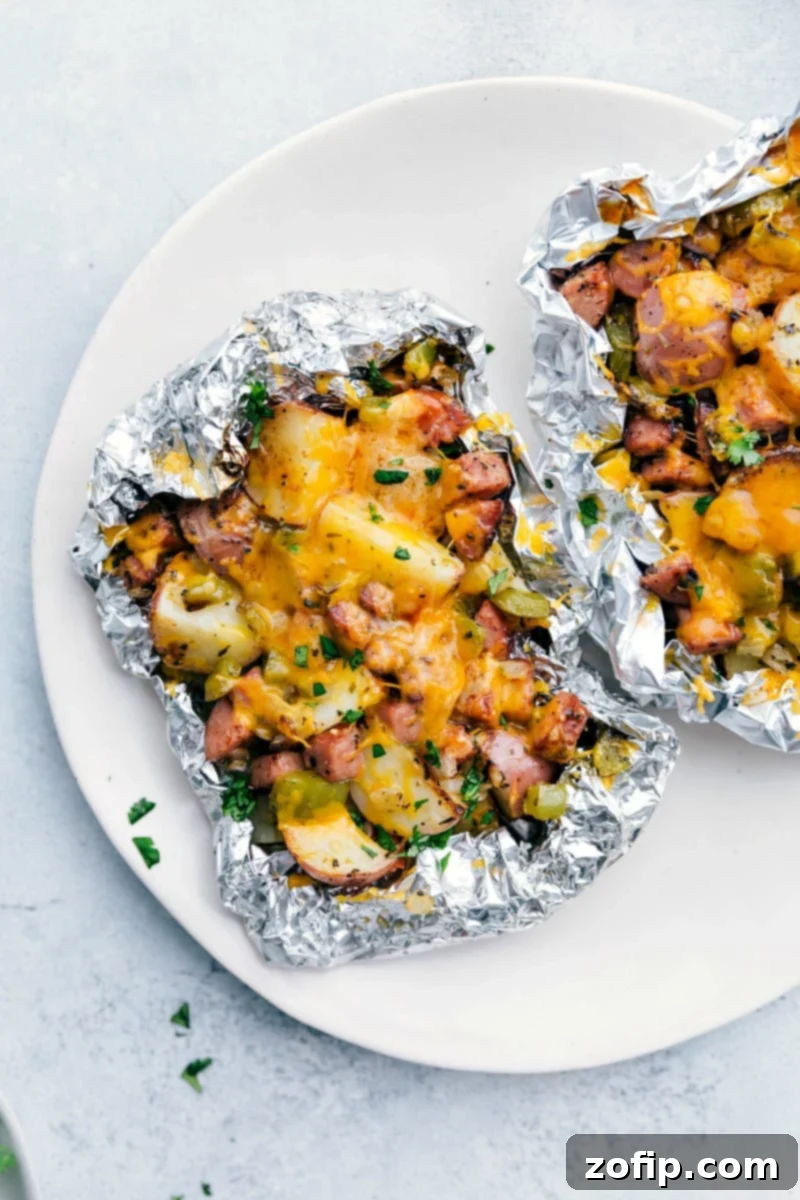 Cheesy sausage and potato foil packs right off the grill.