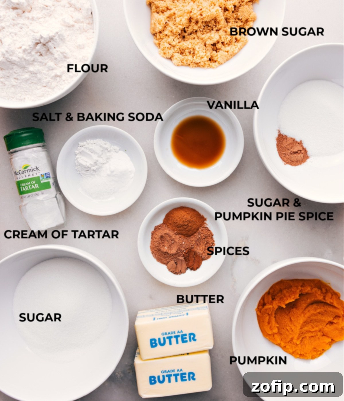 All the essential ingredients for baking pumpkin snickerdoodles, including vibrant spices, creamy butter, various sugars, and finely milled flour, neatly arranged and ready for preparation.