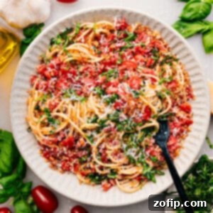 Fresh Tomato and Basil Bruschetta Pasta 6 A bowl of Bruschetta Pasta with fresh basil leaves and a crispy topping.