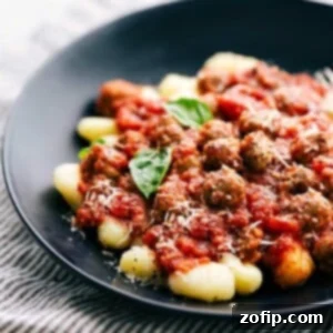 Pillowy Gnocchi with Savory Sausage 6 Sausage Gnocchi with rich tomato sauce and fresh basil.