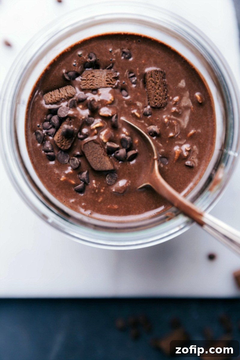 A finished jar of brownie batter overnight oats recipe, beautifully prepared and ready to be enjoyed as a deliciously sweet and healthy breakfast.