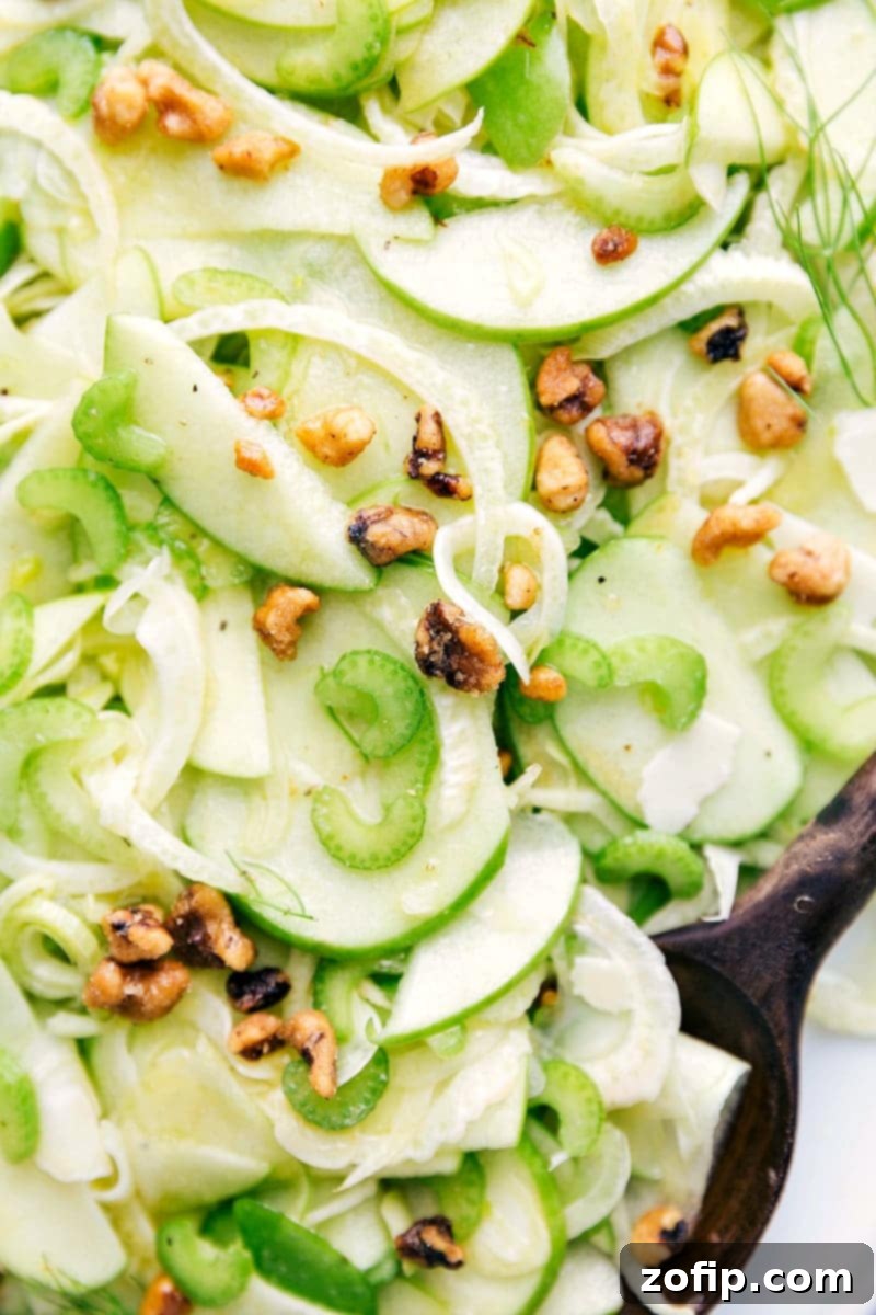 Refreshing Apple Fennel Crunch 2 Close-up shot of the Apple Fennel Salad, highlighting the crisp texture of the thinly sliced apples and fennel, interspersed with celery, walnuts, and cheese