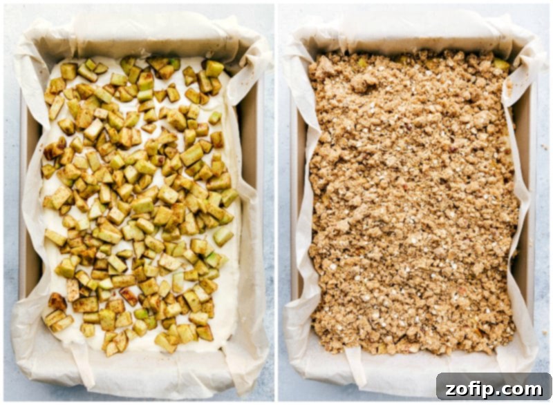 Apple and Cheesecake Layers Topped with Streusel A beautifully layered dessert showcasing the baked graham cracker crust, creamy cheesecake, spiced apple filling, and crumbly streusel topping, ready to be chilled.