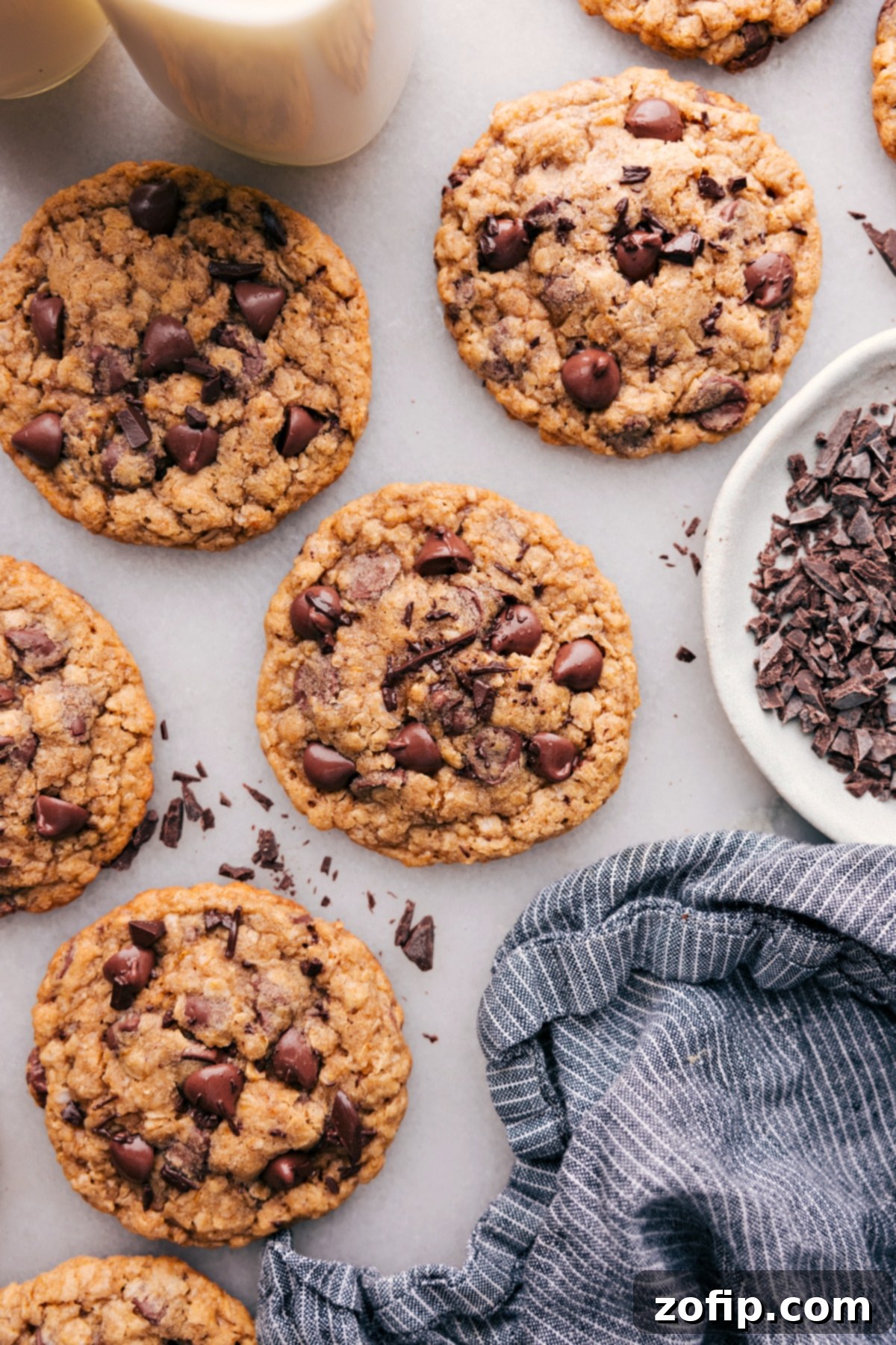 Freshly baked coconut oil oatmeal cookies with gooey chocolate chips, cooling on a rack.