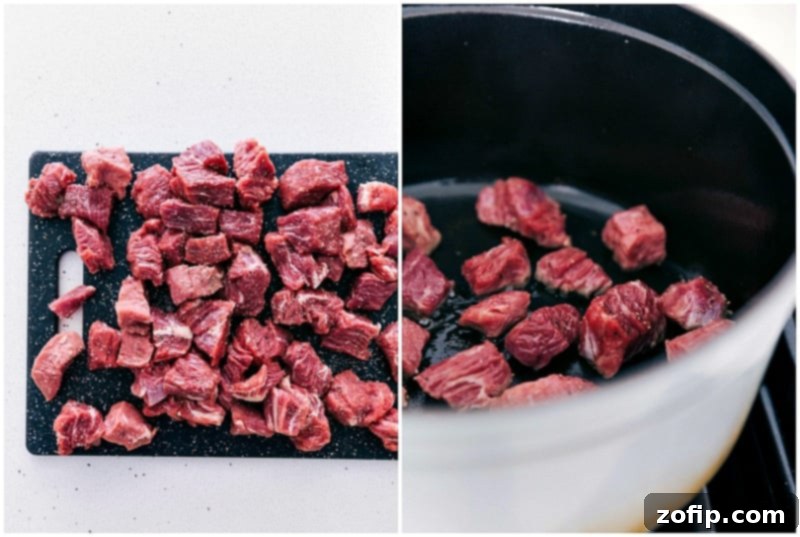 Cubed beef chuck roast being prepared and seasoned for the slow cooker beef and barley soup.