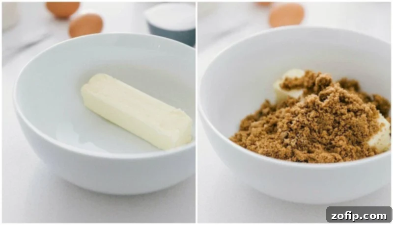 Achieving the perfect base: Creaming butter with brown and white sugar for soft, chewy, and flavorful oatmeal cookies. Process shot showing softened butter, dark brown sugar, and granulated sugar being creamed together in a mixing bowl with a hand mixer