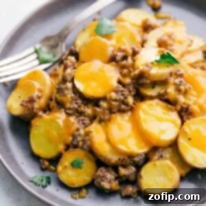 Creamy Crockpot Cheesy Potatoes 3 Close-up of Crockpot Cheesy Potatoes, garnished with fresh parsley.