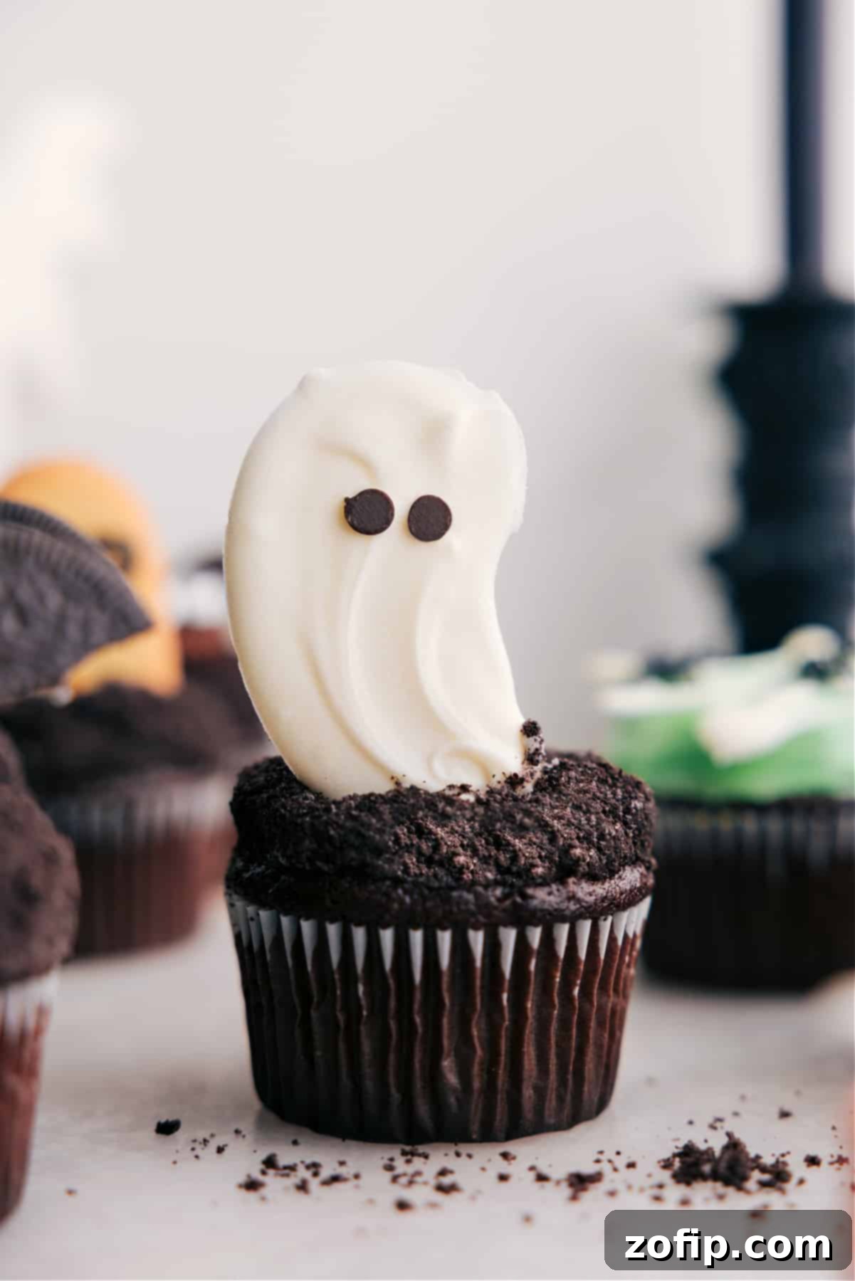 White Chocolate Ghost Halloween Cupcakes Recipe Ghost Halloween cupcakes with white chocolate ghosts and mini chocolate chip eyes.