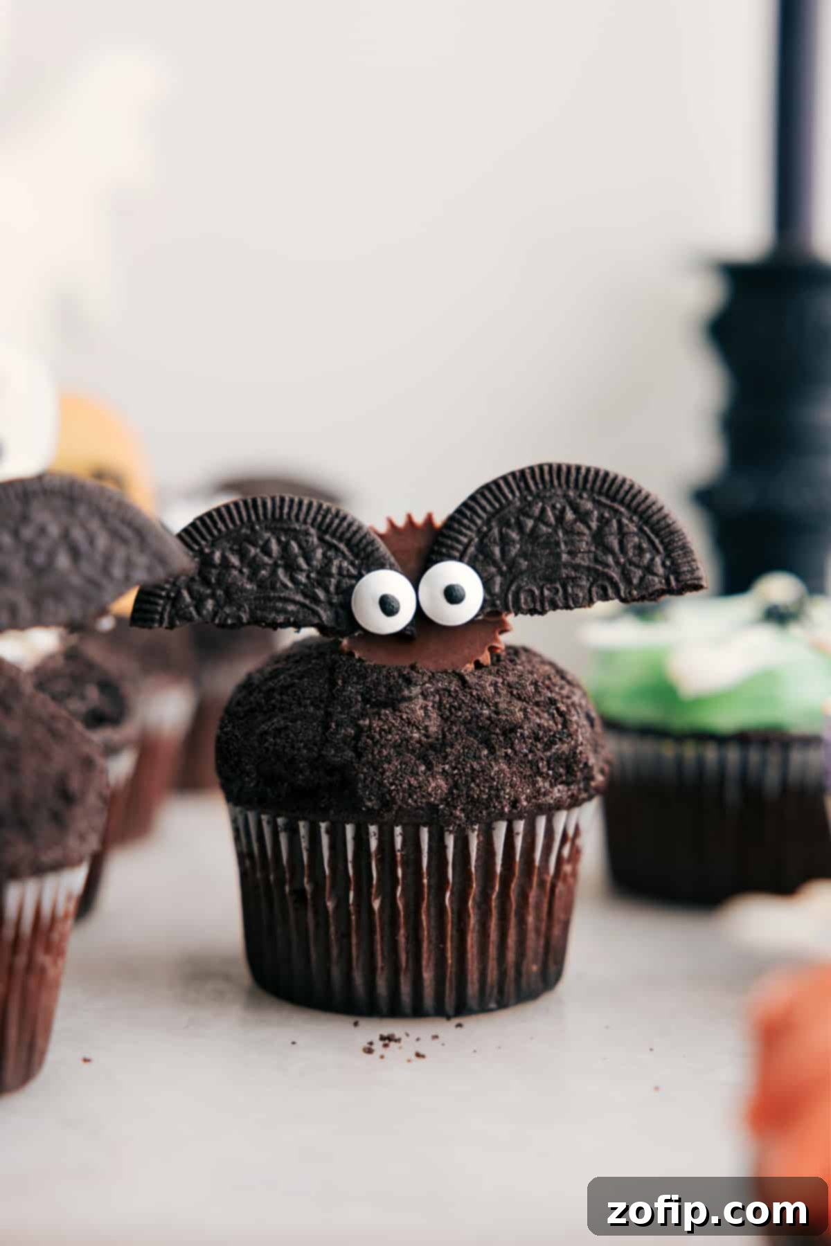 Spooktacular Halloween Cupcakes 2 Bat Halloween Cupcakes made with mini Reese's, Oreos, and edible eyes.