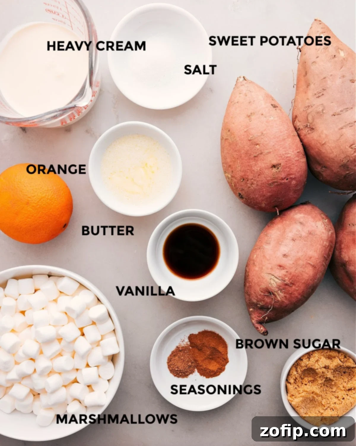 Ingredients In Sweet Potato Casserole All the fresh ingredients required for this sweet potato casserole recipe, including heavy cream, salt, sweet potatoes, an orange, butter, vanilla extract, various seasonings, brown sugar, and marshmallows, neatly prepped for assembly.