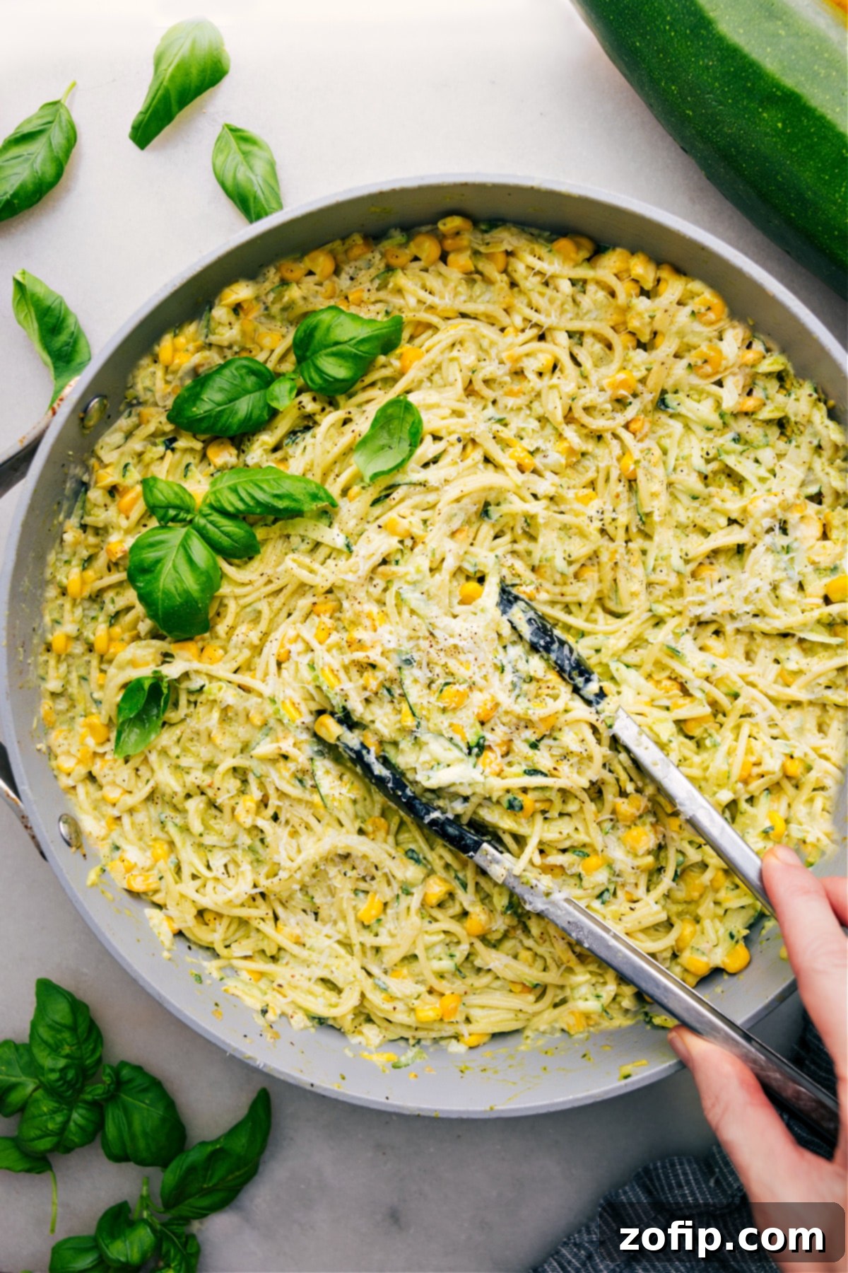 Creamy Zucchini Pasta Sauce over spaghetti in a pot, ready to be served for a delicious summer dinner.