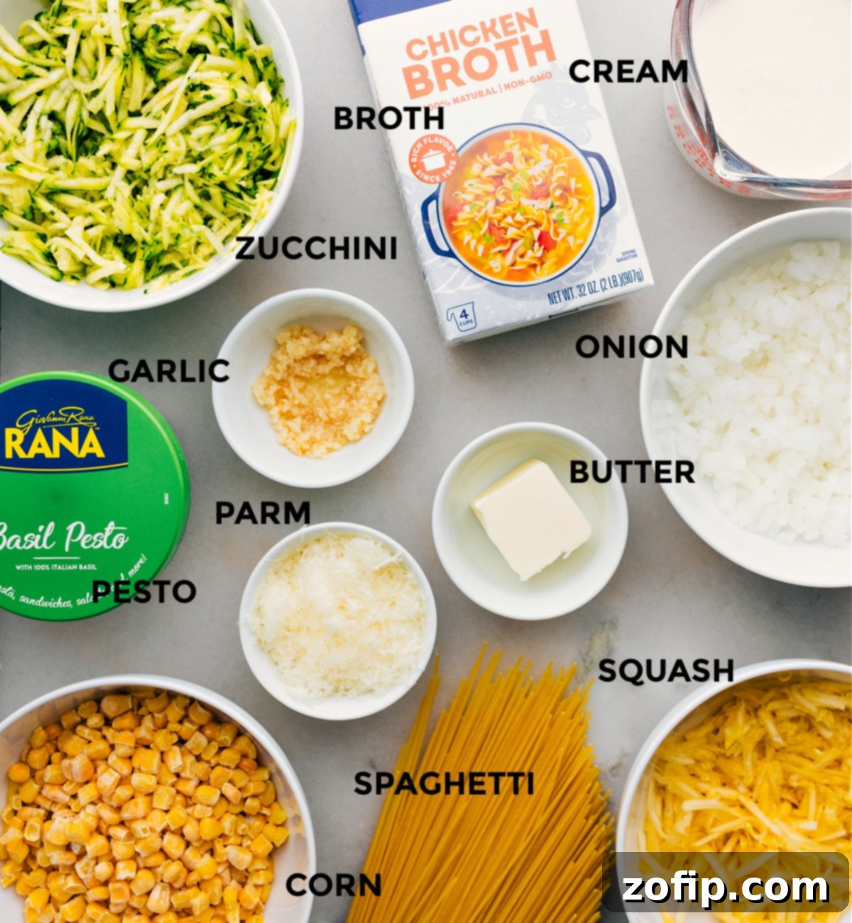 All the fresh ingredients including shredded zucchini, diced onion, garlic, and corn, meticulously prepped and laid out for easy assembly of the Zucchini Squash Pasta.