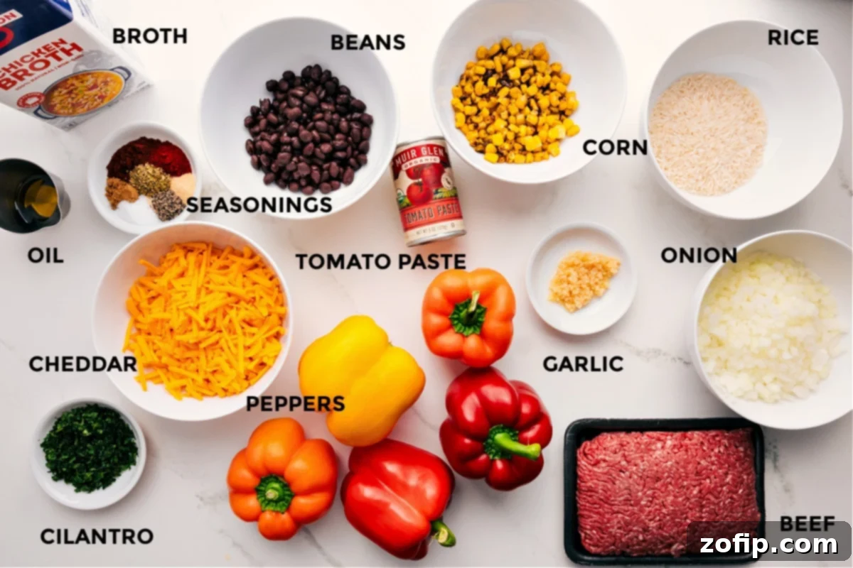 Key Ingredients for Authentic Mexican Stuffed Peppers A vibrant assortment of Mexican stuffed pepper ingredients prepped on a cutting board, including chicken broth, olive oil, a medley of spices, shredded cheddar cheese, fresh cilantro, colorful bell peppers, black beans, tomato paste, minced garlic, lean ground beef, basmati rice, corn kernels, and finely diced onions.