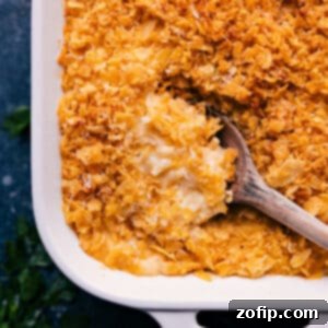 A freshly baked casserole of Funeral Potatoes, featuring a golden, crispy topping and creamy interior.