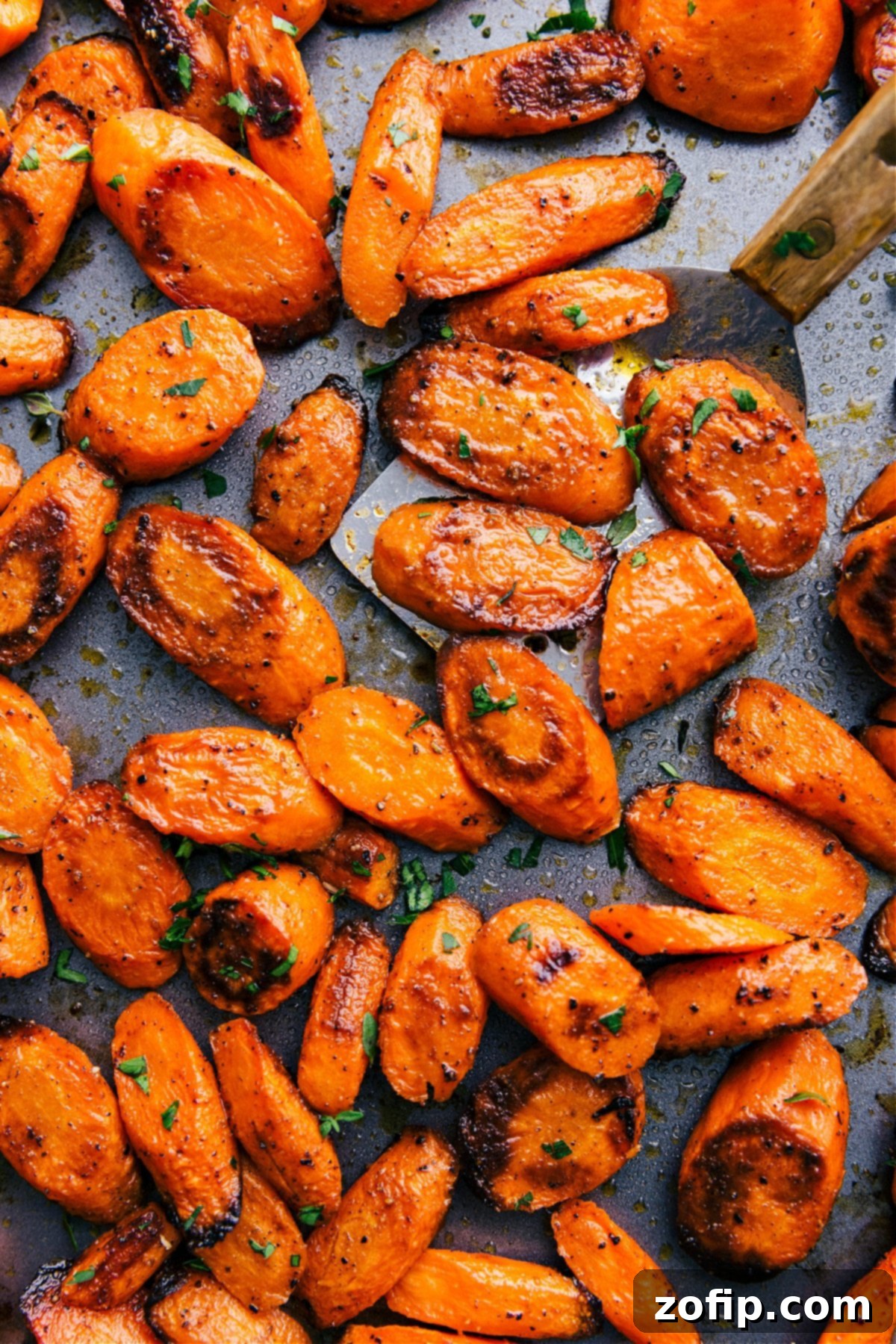 The Best And Easiest Roasted Carrots Recipe Perfectly roasted carrots, golden-brown and tender, served on a baking sheet.