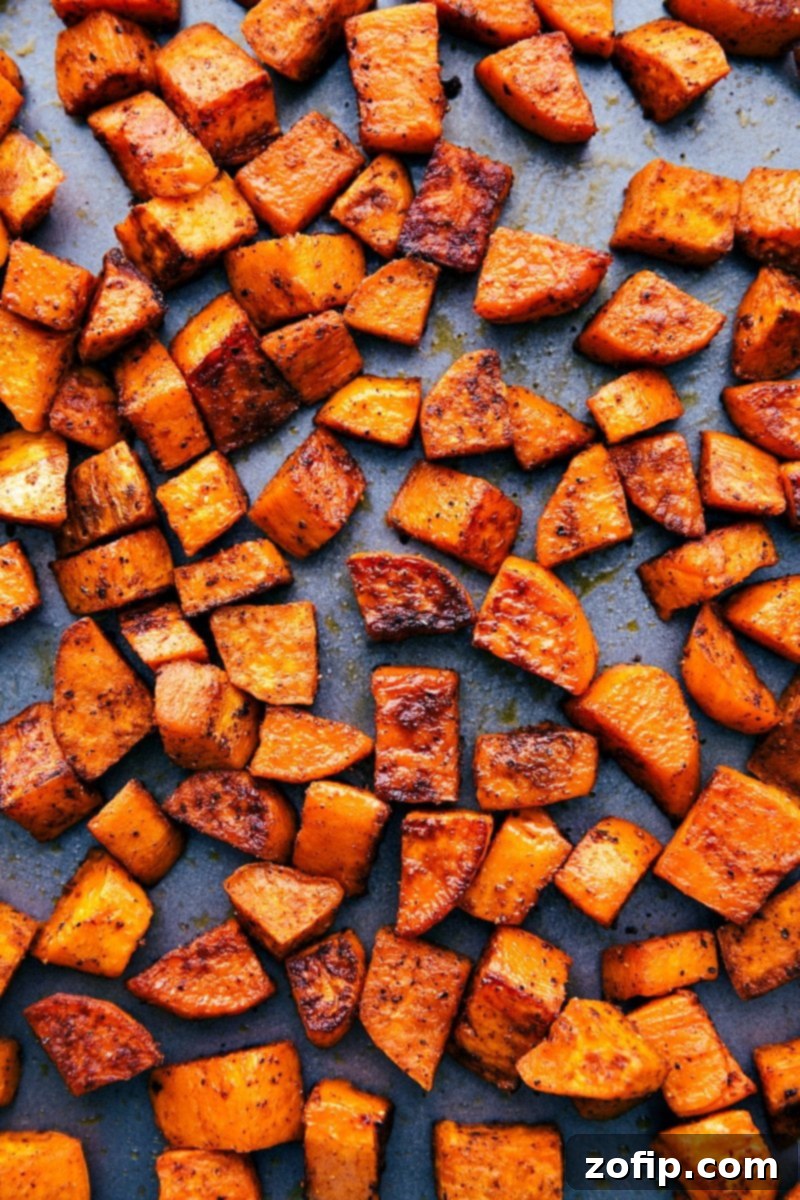 Overhead photo of tray of roasted sweet potatoes, perfectly caramelized and ready to serve
