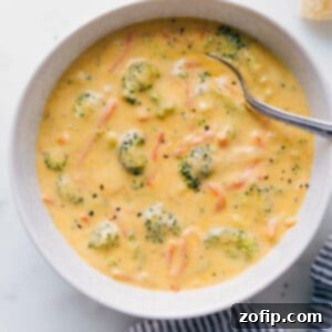 A hearty serving of homemade Broccoli Cheddar Soup in a rustic white bowl, ready to be enjoyed.