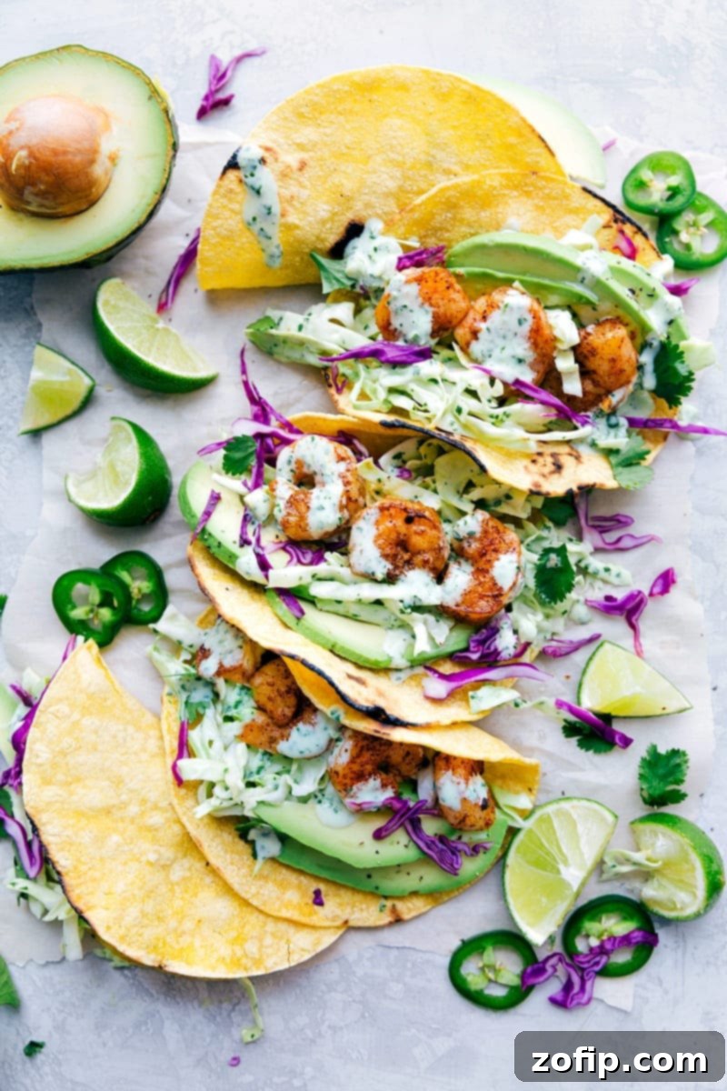 Flavorful Shrimp Tacos filled with vibrant slaw, creamy avocado, and delicious toppings, beautifully arranged on a plate.