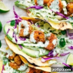 Beautifully arranged shrimp tacos, showing the seasoned shrimp, cilantro-lime slaw, and avocado slices.