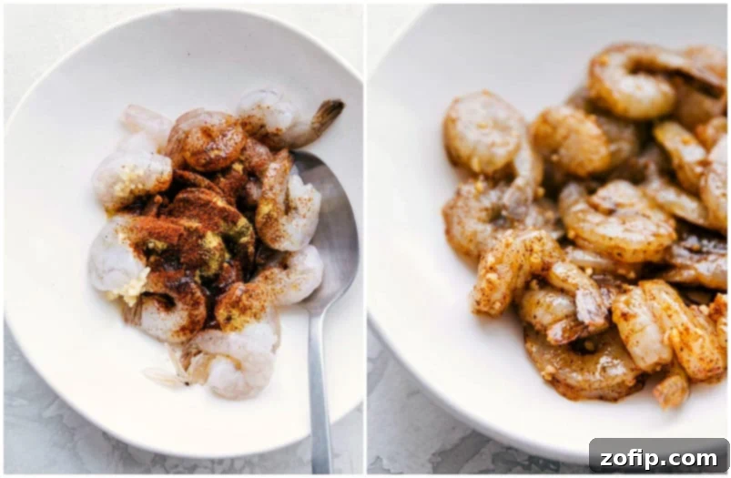 Raw shrimp seasoned with spices and olive oil, laid out on a cutting board, ready to be cooked for shrimp tacos.