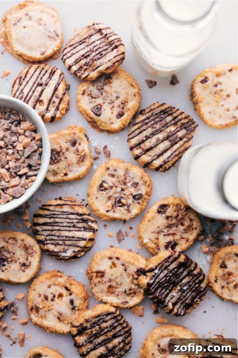Buttery Toffee Shortbread 2 Beautifully arranged Toffee Shortbread Cookies with crisp, sugared edges and a chocolate drizzle, perfect for the holidays.
