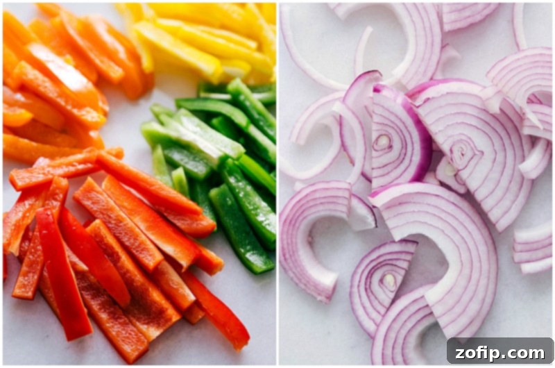 Assortment of freshly cut vegetables, including sweet potatoes, bell peppers, and onion, prepared for vegetarian fajitas.