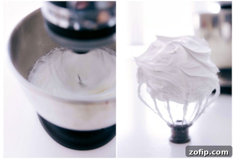 A close-up of egg whites and sugar being whipped into stiff peaks in a metal bowl, illustrating the essential first step of making meringue cookies.