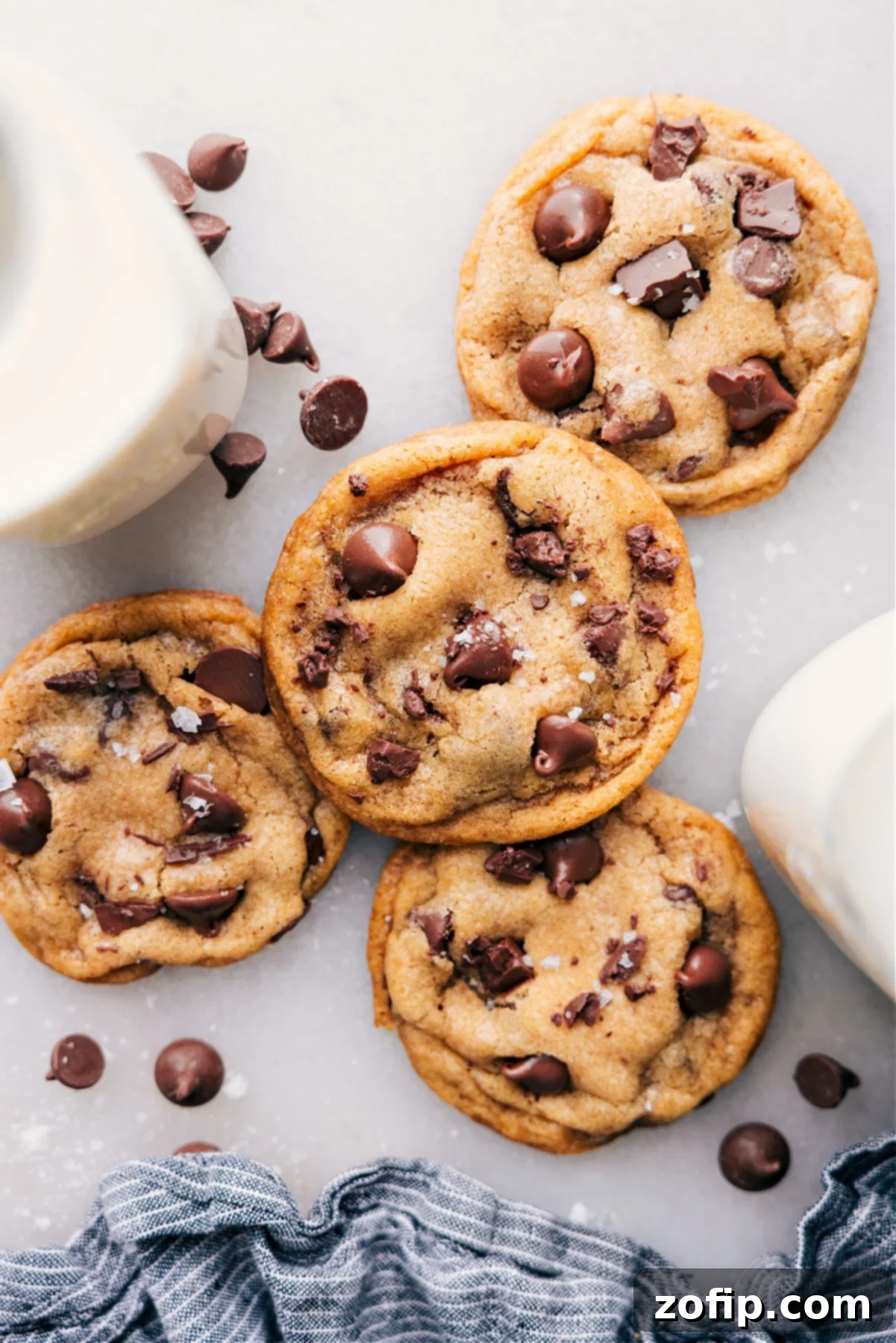 Warm coconut oil chocolate chip cookies sprinkled with sea salt, fresh from the oven, showcasing their golden-brown edges and molten chocolate chips.