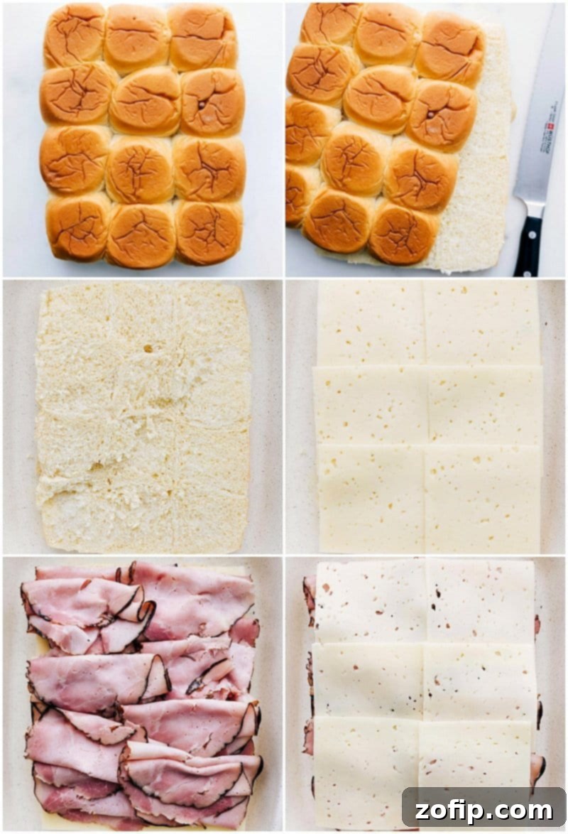 Layering ham and cheese on Hawaiian rolls in a baking pan.